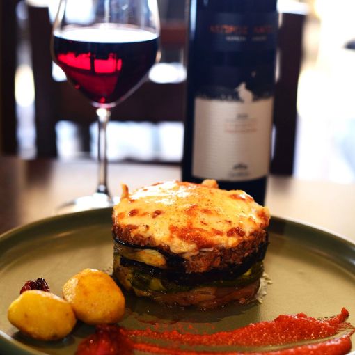 Moussaka with wine served